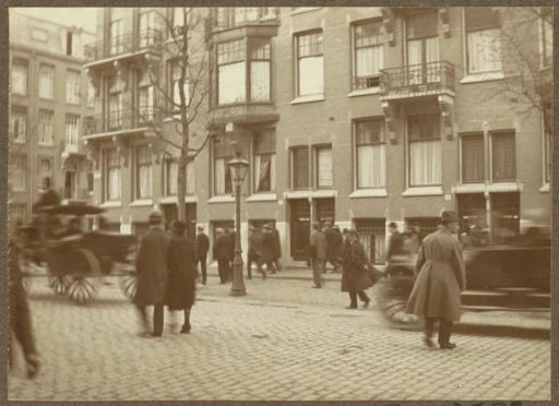 Passers-by in the Okeghemstraat in Amsterdam, at the corner with the Valeriusstraat