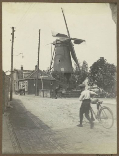 Boys with bicycles and a handcart on the Amsteldijk in Uithoorn, near a mill