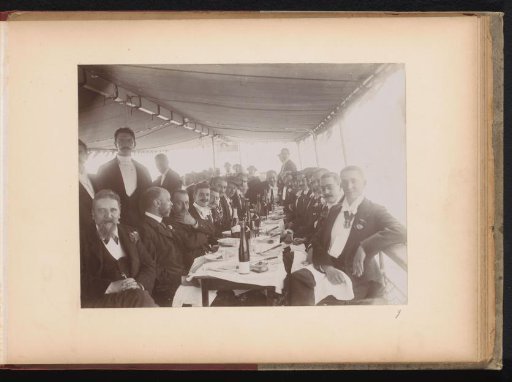 Group of members of the Amsterdam Student Corps at a table on a tour boat