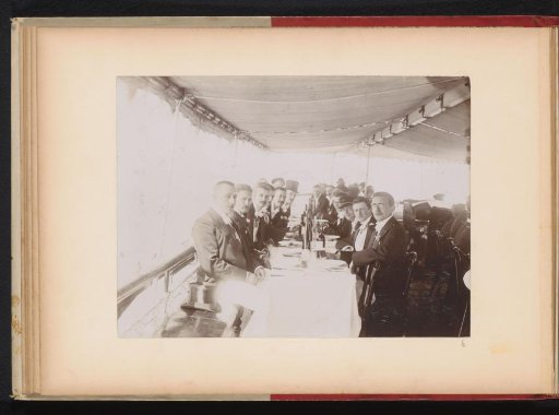 Group of members of the Amsterdam Student Corps at a table on a tour boat