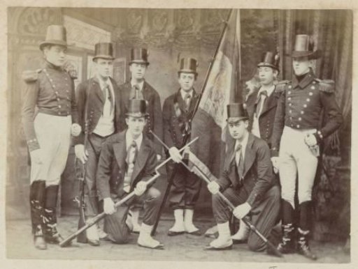 Group portrait of eight unknown men in historical military uniforms and costumes on the occasion of the independence celebrations in Dordrecht