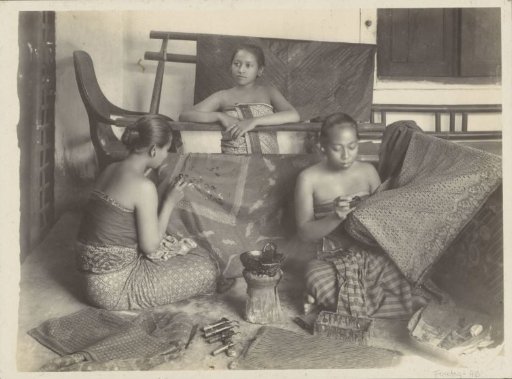 Three women making batik