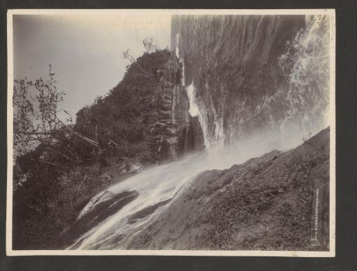 Coast of the Dutch East Indies with a waterfall emptying into the sea