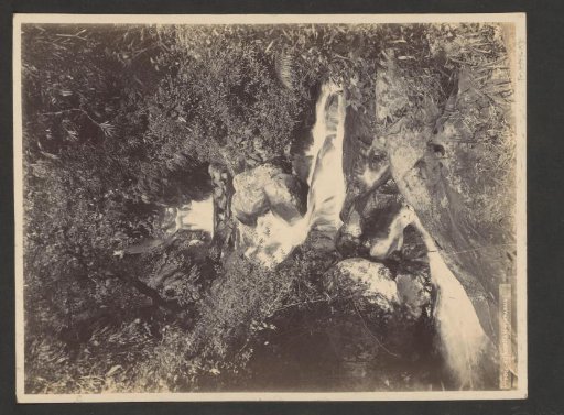 Waterfall in a forest in the Dutch East Indies