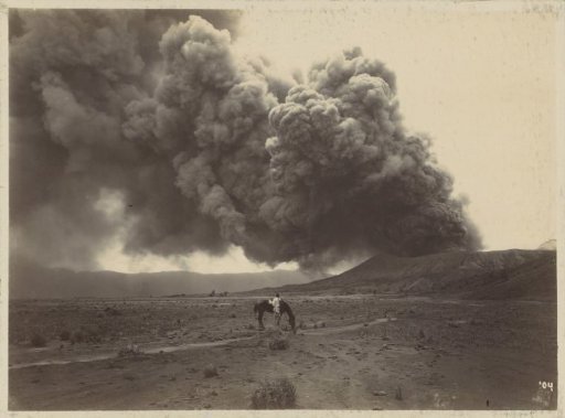 Man with a horse in front of a smoking volcano in the Dutch East Indies