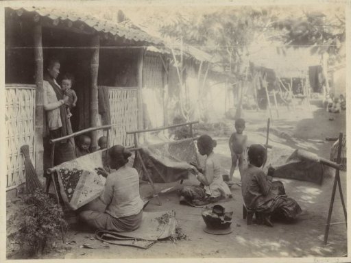Women making batik on a courtyard
