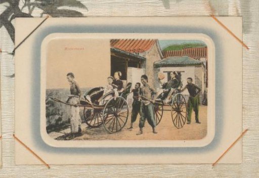 Rickshaw pullers with two female passengers in front of a building