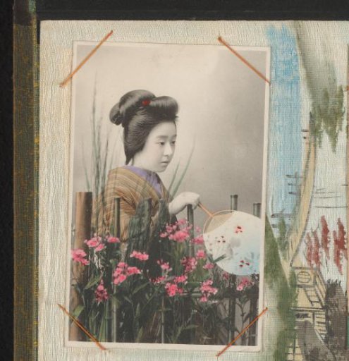 Japanese woman standing behind a fence with plants