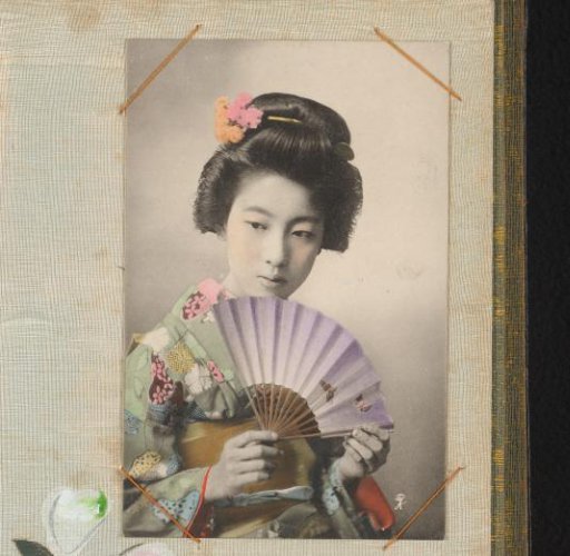 Japanese woman in a green kimono with an open fan
