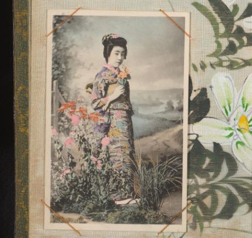 Japanese woman in a colored kimono with flowers in her hand, standing before a landscape backdrop