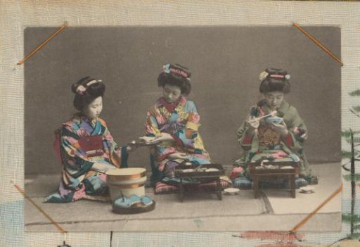 Three Japanese women in colored kimonos eating rice