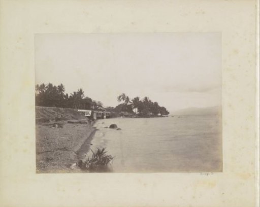 Railway bridge with a train alongside a waterway in the Dutch East Indies