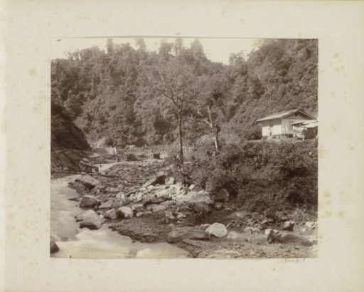 Workers at work on a railway bridge over a stream in the Dutch East Indies