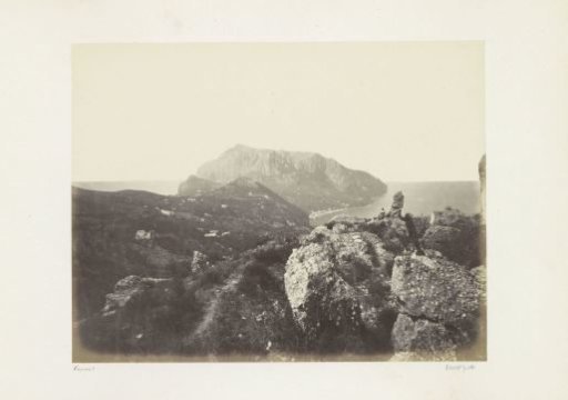 Woman sitting on a rock with a view over the sea on Capri