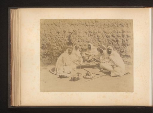 Group of caids with a game and tea