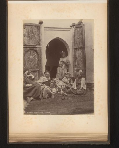Men and women sitting by an open door