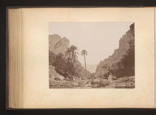 Two men by a riverbed in a gorge