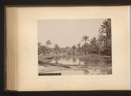 Two men with a child at a watering place in Biskra
