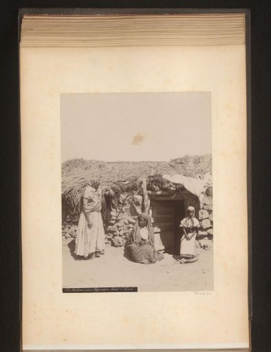 Family in front of a house in Algeria