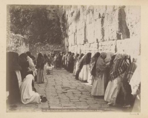 Praying believers at the Wailing Wall in Jerusalem