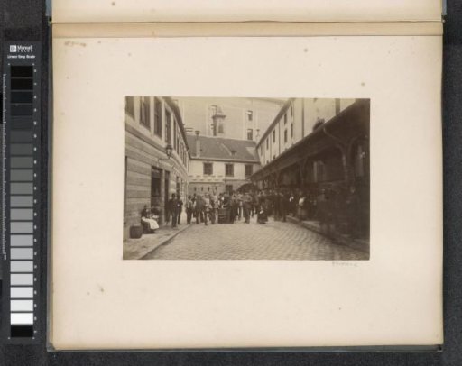 Group of people with jugs near a barrel on the street, probably in Germany