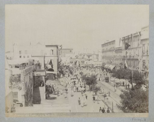 View of the Avenue de France in Tunis with city gate, shops and passers-by on 14 July (quatorze juillet)