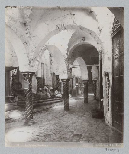 Arcade with seated figures in the perfumery souk of Tunis
