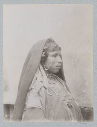 Portrait of a Tunisian woman with a headscarf, earrings and jewellery