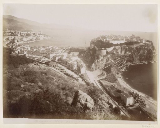 View of Monaco with the old fortified city on the right and a railway station in the middle left