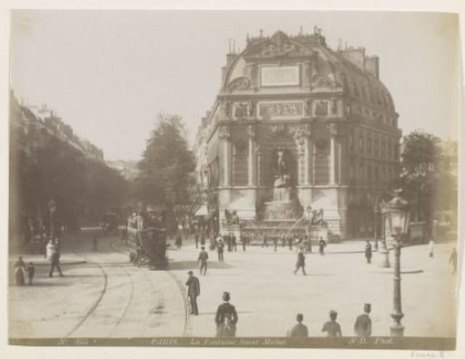 Fontaine Saint-Michel in Paris with tram and passers-by