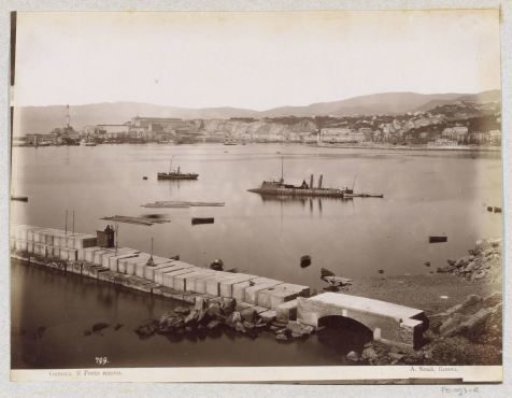 View of the new harbour of Genoa with a training ship of the Scuola Officina di Redenzione sul mare in the middle