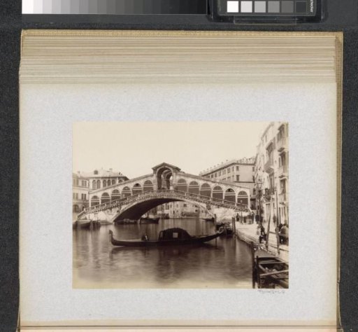 Rialto Bridge over the Grand Canal in Venice with a gondola in the foreground