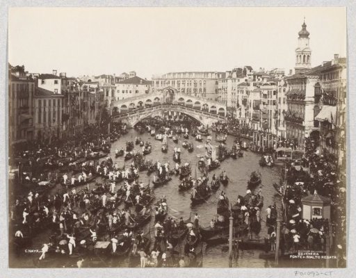 Regatta of gondolas on the Grand Canal in Venice at the level of the Rialto Bridge