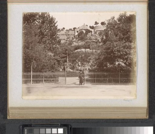 Man standing at the entrance to the Villetta Dinegro park in Genoa