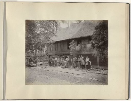 Women with children in front of a house on Sumatra