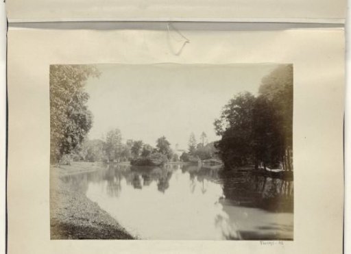 Water in the Dutch East Indies with a bridge and a church tower at the end