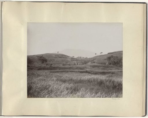 Soldiers and porters in a mountain landscape in the Dutch East Indies