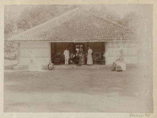 Dutch people in front of a house with Buddha images in the Dutch East Indies