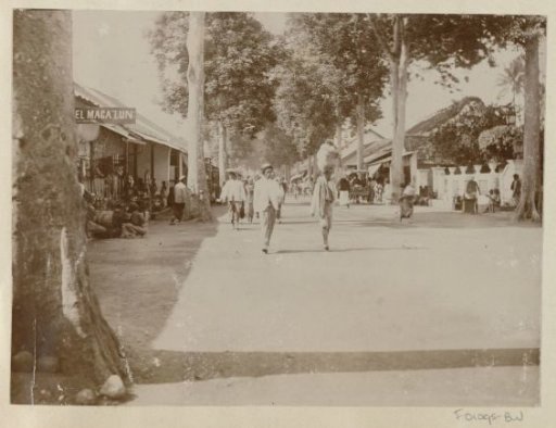 Street scene in the Dutch East Indies with passers-by and shops