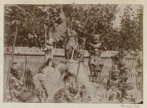 Group of wooden statues in the open air in the Dutch East Indies