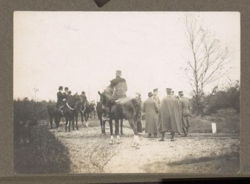 Equestrian scene at the Royal Game Preserve Het Loo: riders with a pack of hounds on a country road