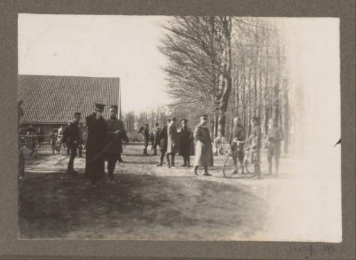 Equestrian scene at the Royal Forest Estate Het Loo: uniformed men with bicycles at a barn