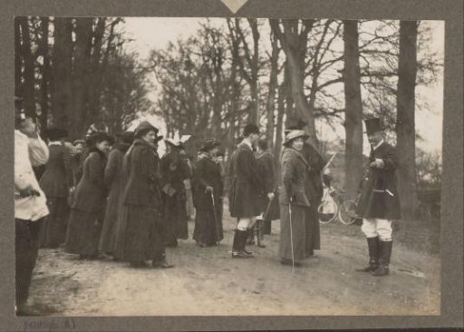 Equestrian scene at the Royal Forest Estate Het Loo: riders and public on a country road, man catches the photographer