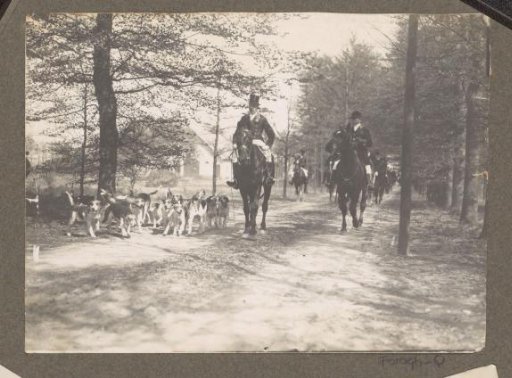 Equestrian scene at the Royal Hunting Lodge Het Loo: riders with a pack of hounds on a country road