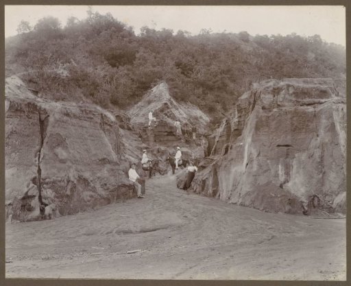 Men, women and horses in a ravine in the Dutch East Indies