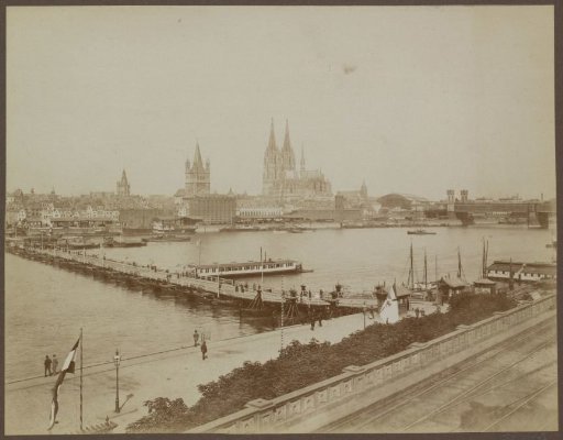 View of Cologne with pier, boats, cathedral and bridges over the Rhine