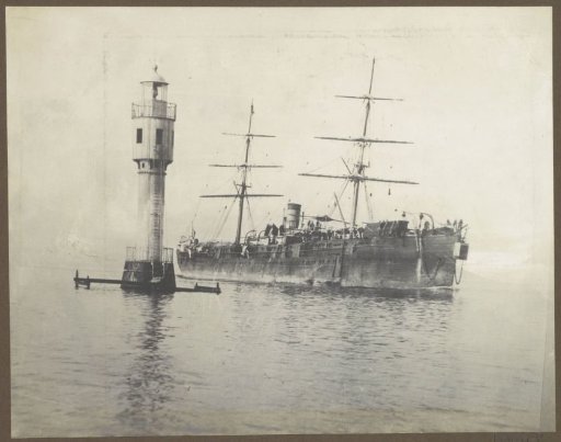 Ship passes a lighthouse, presumably near the Suez Canal