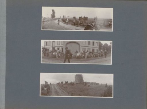 Soldiers with cars, horses and knapsacks in front of a windmill in France