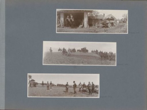 Soldiers by a barn with a trailer in France