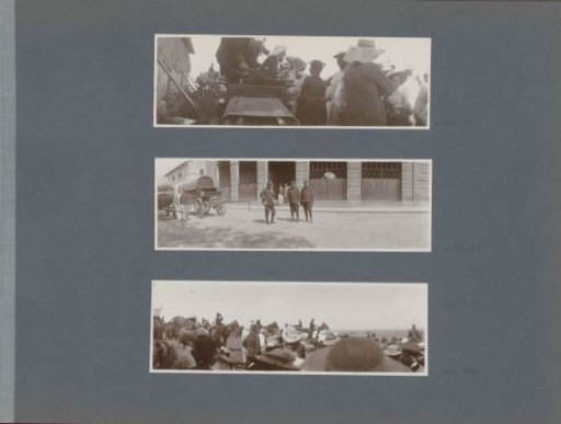 Soldiers near carriages in front of a building in France